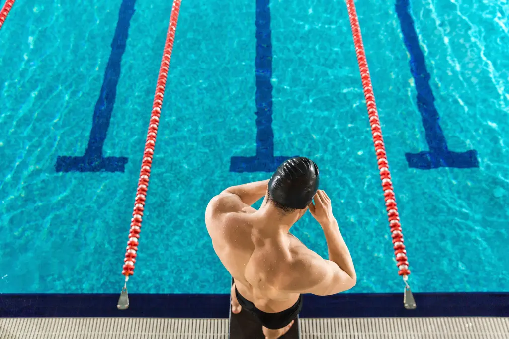 rear-view-of-a-man-preparing-swimming-goggles.jpg